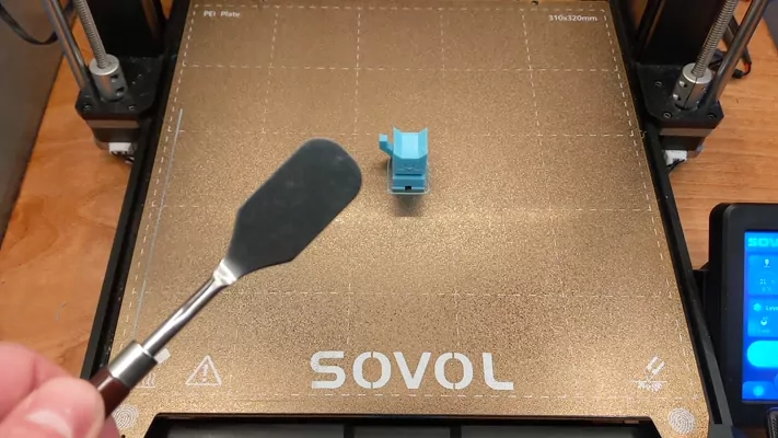 Removing the purge line from the build plate with the scraper